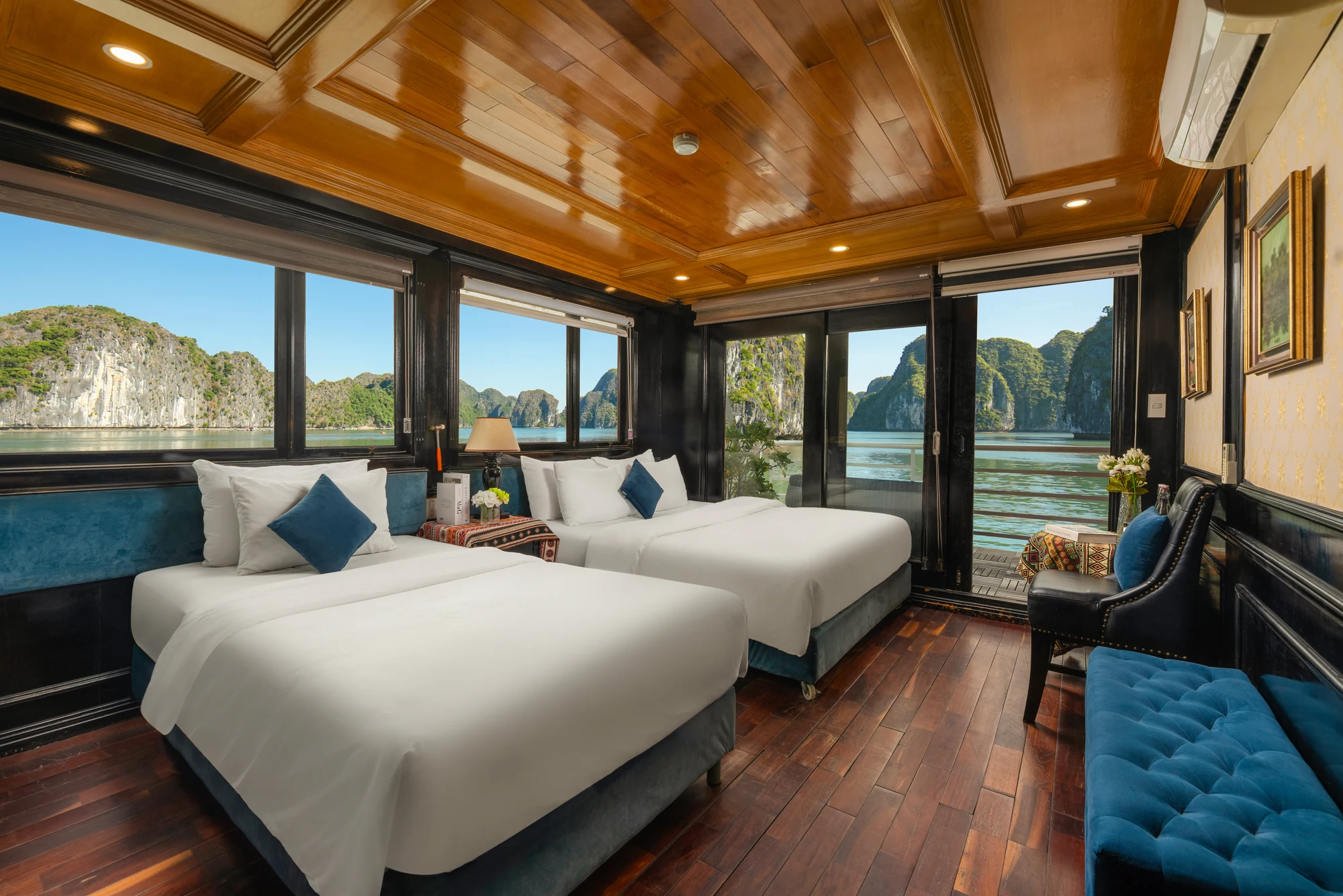 Triple Ocean View with Private Balcony cabin with a double bed, a single bed and glass doors to the balcony on Quiet Bay Cruise