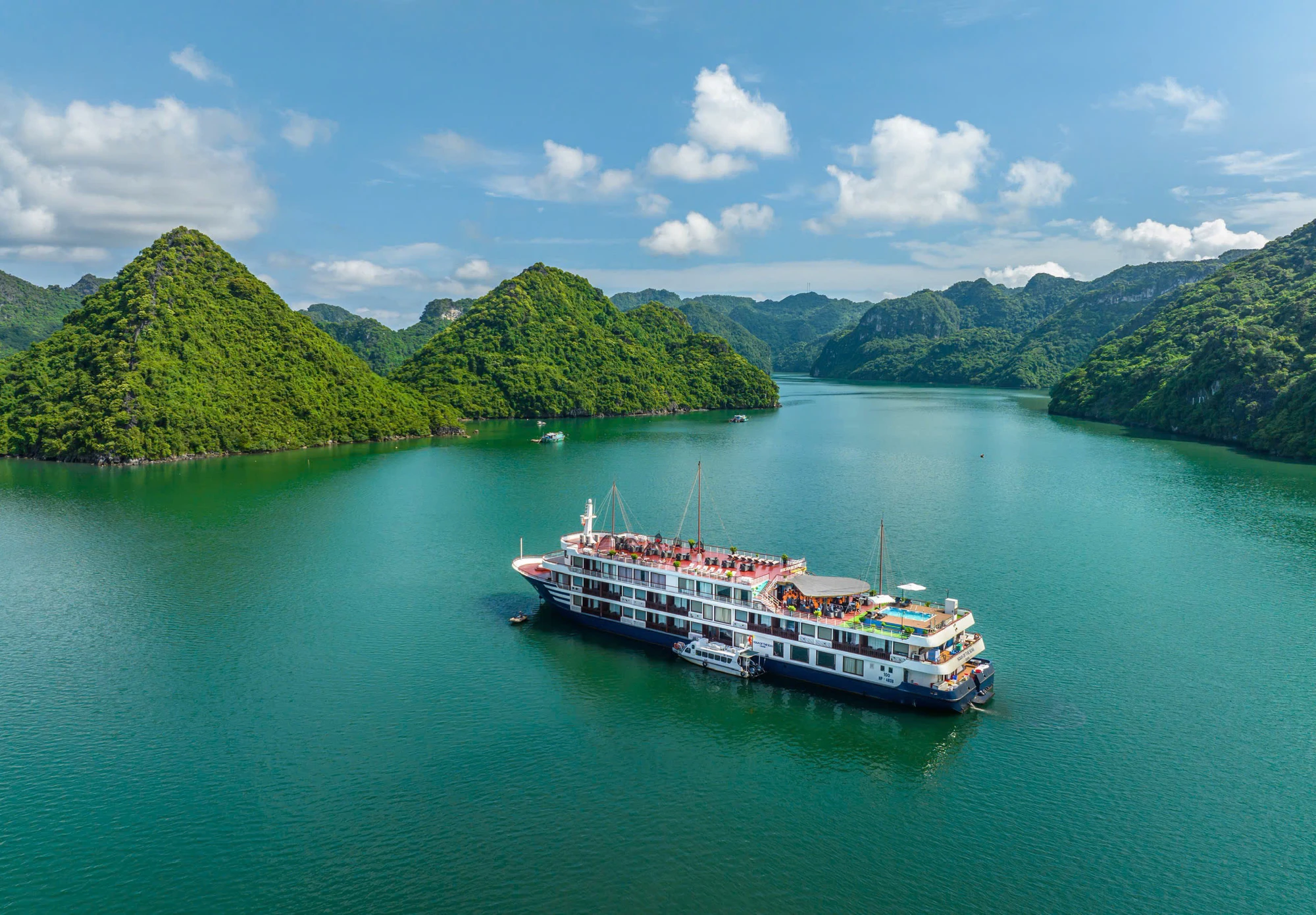 Aqua of the Seas overnight cruise vessel among limestone islands on Lan Ha Bay